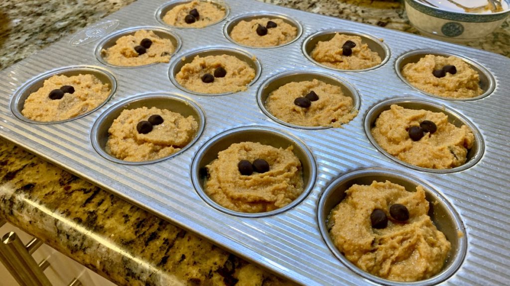 A muffin tray filled with muffin batter